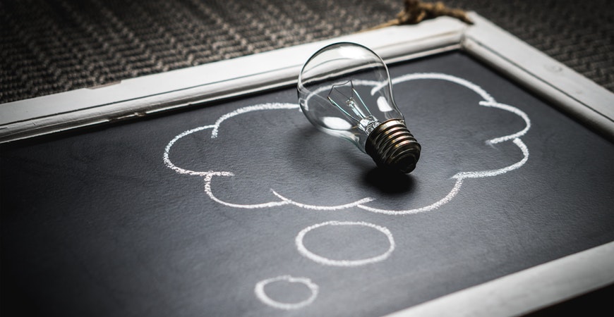 lightbulb in thought bubble on chalkboard